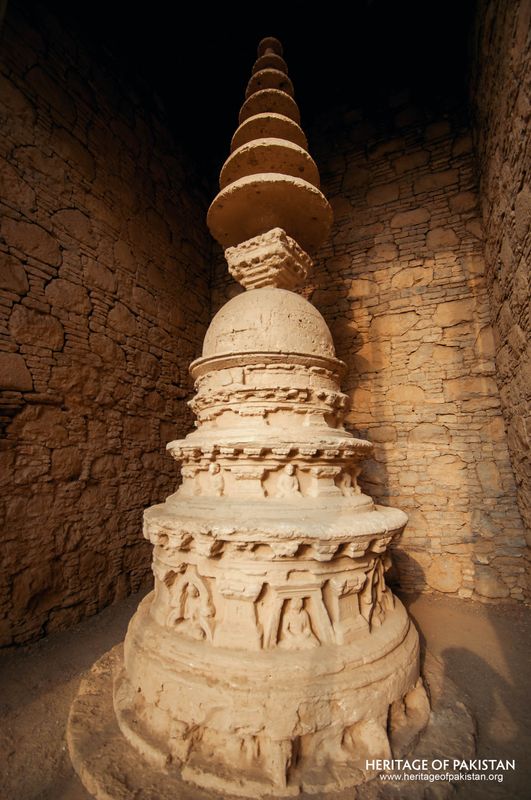 Detailed stonework and relief carving mark this votive structure at Mohra Moradu.
